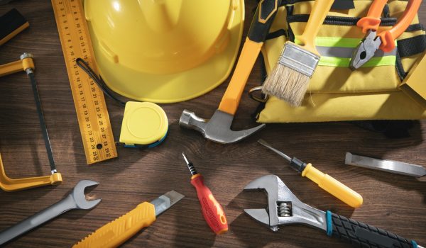 Work tools on the wooden background.